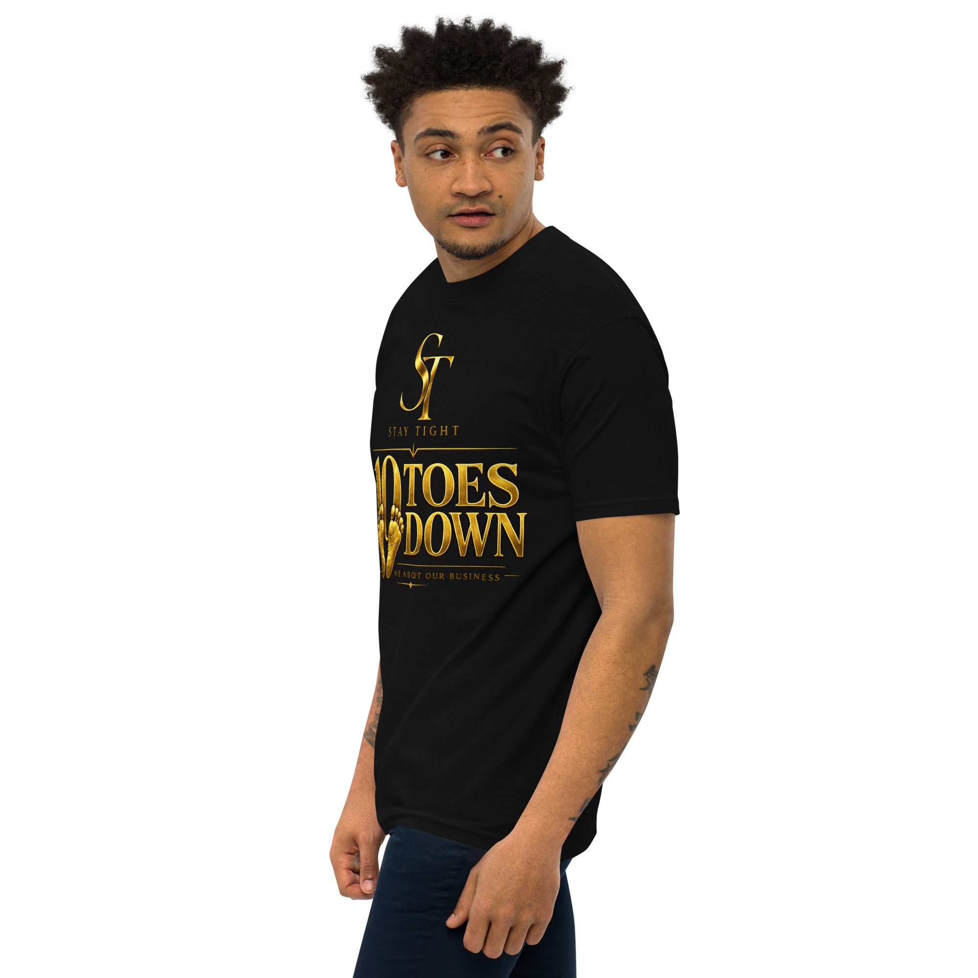 premium heavyweight Stay Tight graphic T-shirt with a bold “10 Toes Down” design featuring gold footprints and the phrase “We About Our Business.” Motivational streetwear representing discipline, focus, loyalty, resilience, and commitment.