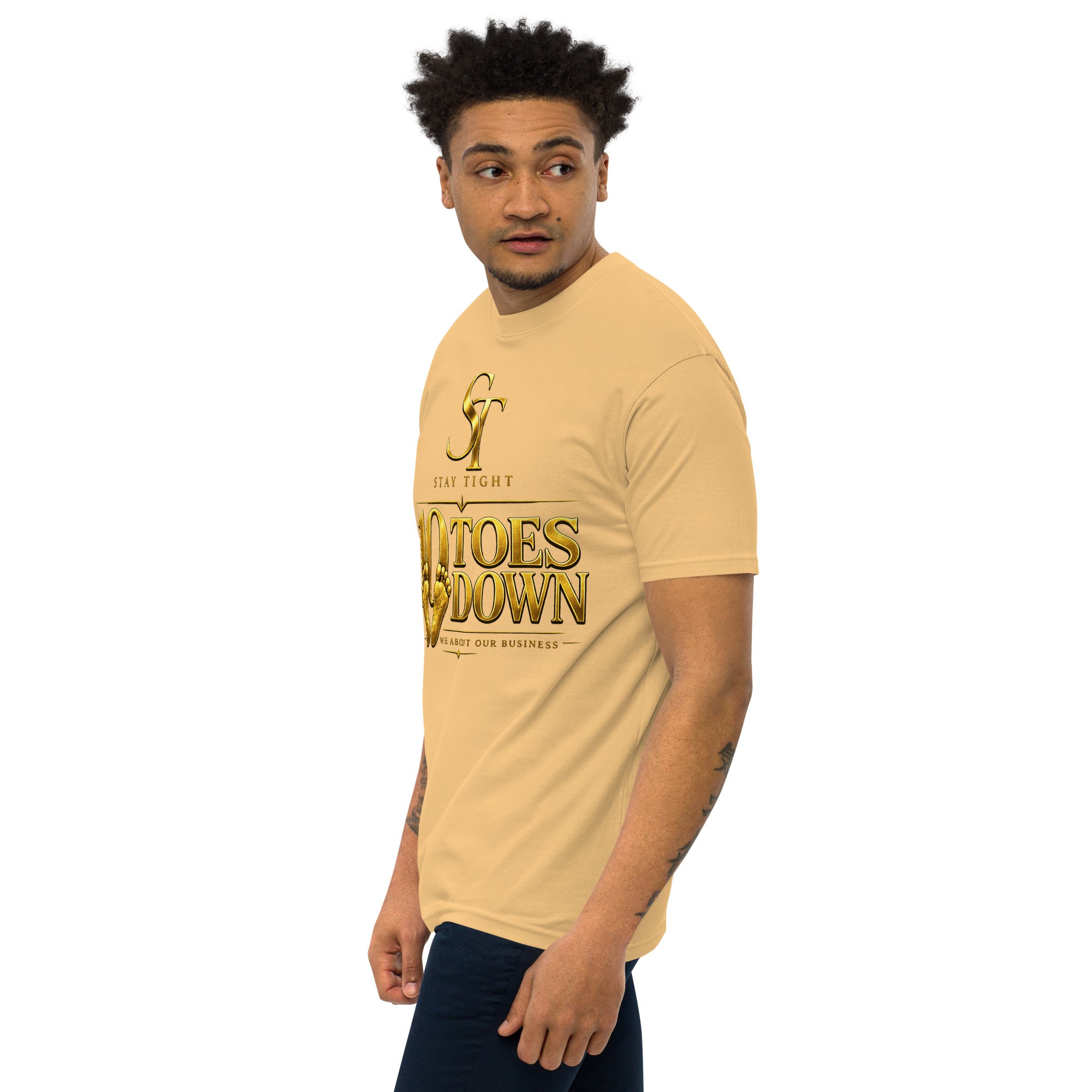 premium heavyweight Stay Tight graphic T-shirt with a bold “10 Toes Down” design featuring gold footprints and the phrase “We About Our Business.” Motivational streetwear representing discipline, focus, loyalty, resilience, and commitment.